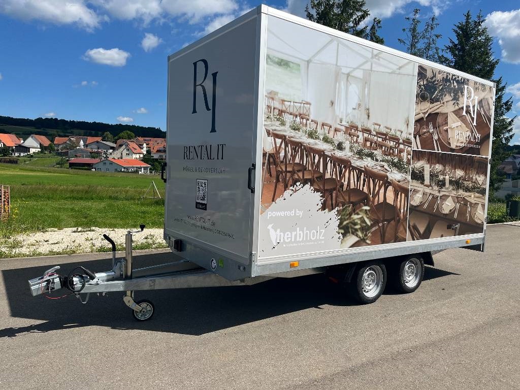 Unser RENTAL-IT Kofferanhänger mit Möbelmotiven, Firmenlogo und Deichsel